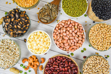 Different whole grains beans on bowl and legumes seeds lentils and nuts colorful snack background top view - Collage various beans mix peas agriculture of natural healthy food for cooking ingredients