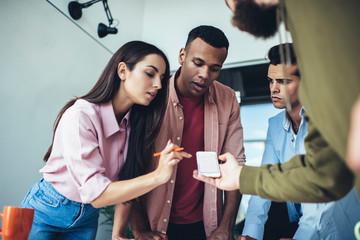 Millennial hipster guys checking notification for cellphone application connected to 4g wireless...