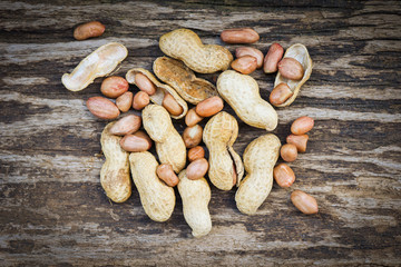 Obraz premium Peanut in shells for food or snack / Roasted peanuts on rustic wood background