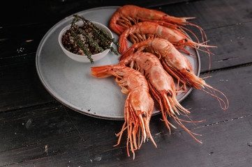 Raw king prawns on a dark wooden table. Close-up. Sea food.