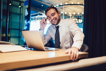 Confident businessman surfing on laptop in office