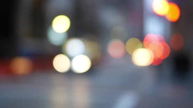 Indie hipster defocused handheld city bokeh in downtown area on overcast day - traffic bokeh