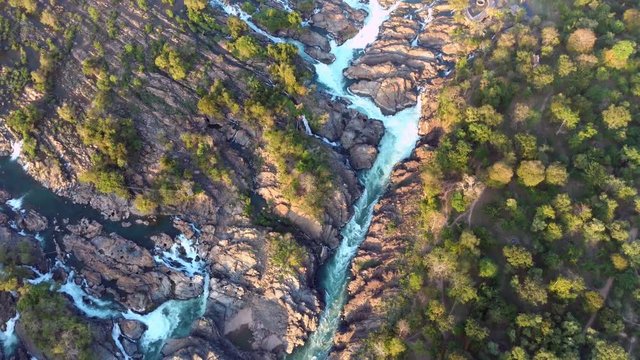 Drone aerial flight over riverbed that leads through rocky terrain in Mekong,Laos