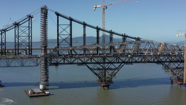 Hercilio Luz Bridge under restoration works with huge cranes, aerial shot