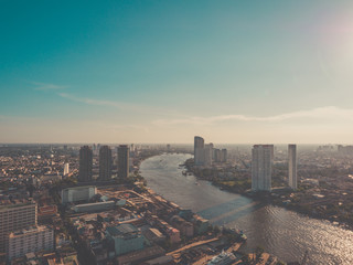 Aerial view of Bangkok skyline and skyscraper on Sathorn Road center of business in Bangkok downtown.Taksin Bridge over Chao Phraya River Bangkok at Thailand