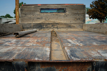 The rear end of an old flatbed truck.