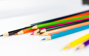 The crayon is on the white paper.