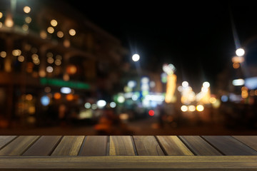 Empty dark wooden table in front of abstract blurred bokeh background of restaurant . can be used for display or montage your products.Mock up for space.