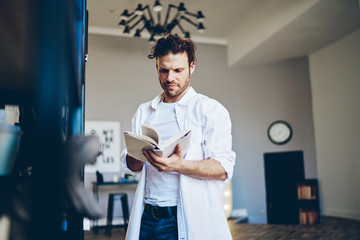 Focused man reading in living room