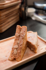 french toast with peanut butter on wood dish