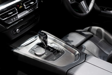 Fototapeta na wymiar Luxury of car interior at transmission shift gear area. Modern car interior, gearstick radio and air conditioner..