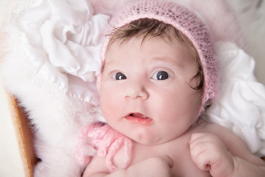 Little newborn baby girl portrait, big eyes and soft skin