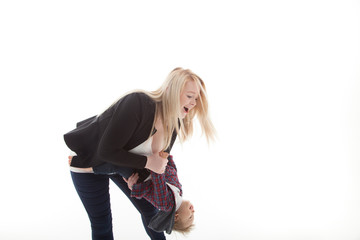 mother tipping child upside down fun and laughing