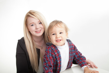 smiling mother and toddler boy on white background