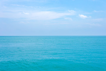 Clean blue sea water or ocean and clear blue sky and white clouds.