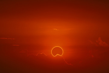 amazing phenomenon of total sun eclipse over cloud sunset red orange sky on the sea