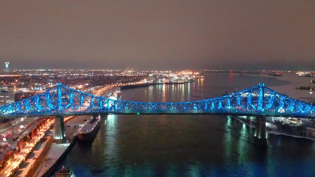 drone close to jacques cartier bridge moving away at night in montreal