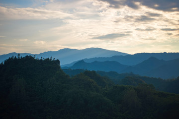 Beautiful mountains and forests with fog.At sunset.