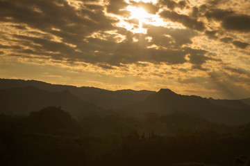 Beautiful mountains and forests with fog.At sunset.