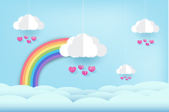 Rainbow and clouds in the blue sky, and pink heart