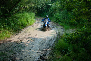 Travelling on an enduro motorcycle in the taiga.