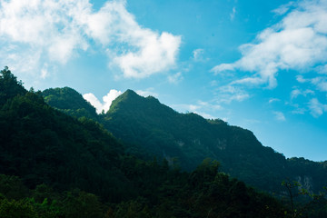 Steep mountains and forests under the sky