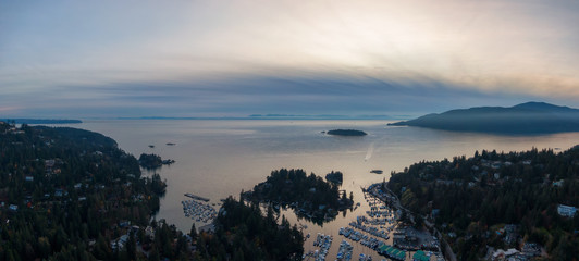 Horseshoe Bay, West Vancouver, British Columbia, Canada. Aerial view of residential homes near the Highway during a bright and sunny sunset in Fall Season.