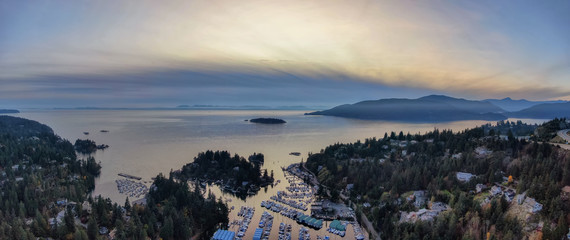 Horseshoe Bay, West Vancouver, British Columbia, Canada. Aerial view of residential homes near the Highway during a bright and sunny sunset in Fall Season.