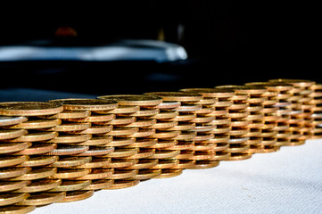 Stack of gold and silver dollar coins forming a border wall 