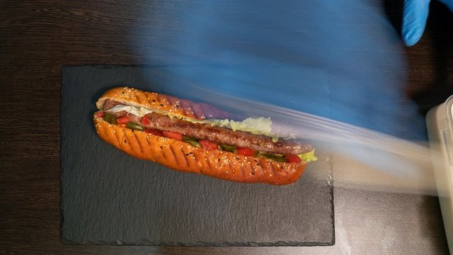 Top view timelapse chef making a hot dog