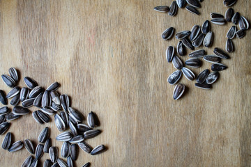 Sunflower seeds on a wooden table. Banner for your text. Seeds striped from a sunflower.
