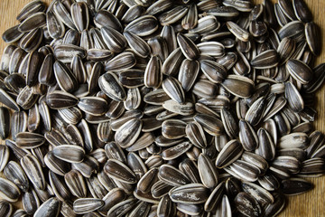 Sunflower seeds on a wooden table. Banner for your text. Texture of seeds.