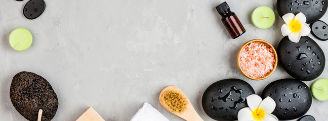 Top view of hot spa stones set for massage treatment on gray concrete background with copy space. Elegant and luxury spa. Flat lay, overhead, mock up, template. Health and beauty care concept