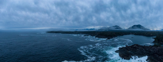 Ucluelet, Vancouver Island, British Columbia, Canada. Aerial Panoramic View of a Small Town near Tofino on a Rocky Pacific Ocean Coast during a cloudy sunrise.