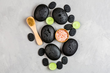 Top view of hot spa stones set for massage treatment on gray concrete background with copy space. Elegant and luxury spa. Flat lay, overhead, mock up, template. Health and beauty care concept