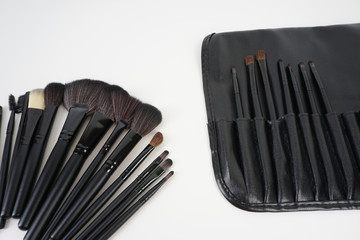 Top view of Professional makeup brushes over black background. Selective focus