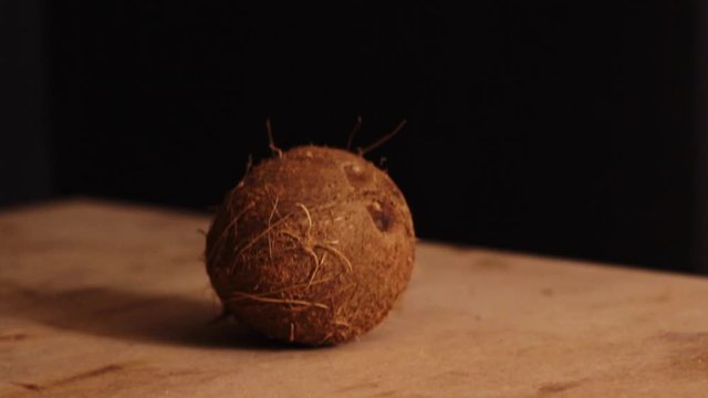 Rotating around a whole coconut on a wooden chopping board