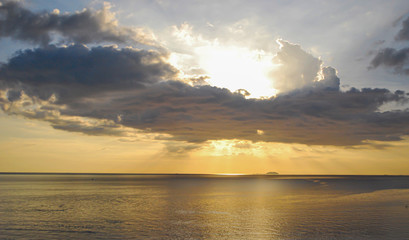The evening sun shining into the sea
