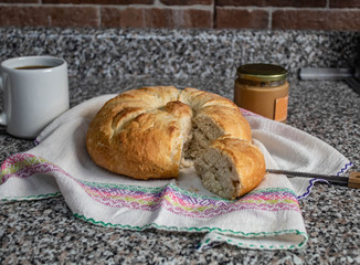 round loaf of bread , coffee and peanut butter