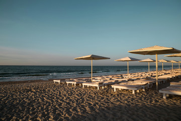 Sea beach with sunbeds and umbrellas