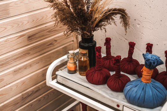 Alternative Medicine. Churna pinda sweda cotton bags filled with a mixture of herbs on table close-up