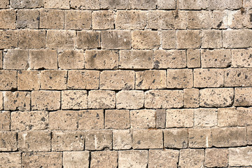 Background from a beige natural stone wall