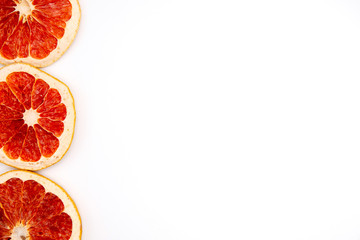 three slice of dried grapefruit close-up on white background