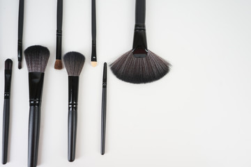 A set of a black make up brushes over the white background
