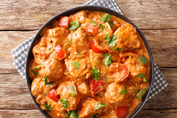 Mafe is a famous and popular West African dish cooked chicken in spicy peanut sauce close-up in a...