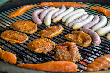 Barbecue grill bbq on coal charcoal grill with steaks bratwurst sausages and meat delicious summer meal