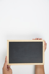 Mens hand holding blackboard over white background. Copy space concept