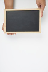 Mens hand holding blackboard over white background. Copy space concept