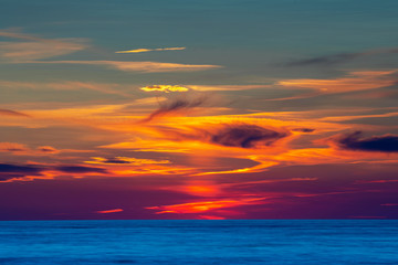 Amazing cloudy summer sunset over deep blue ocean and endless horizon, Baltic Sea Sweden