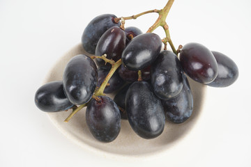 Fresh grape fruits plated over the white background